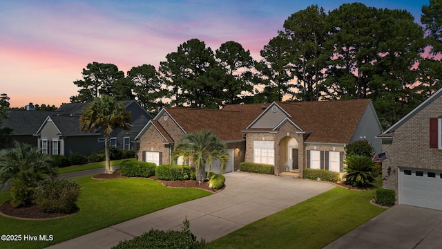 923 Meadowlands Trl, Calabash, NC 28467 - view of front of home with driveway, a lawn, and brick siding