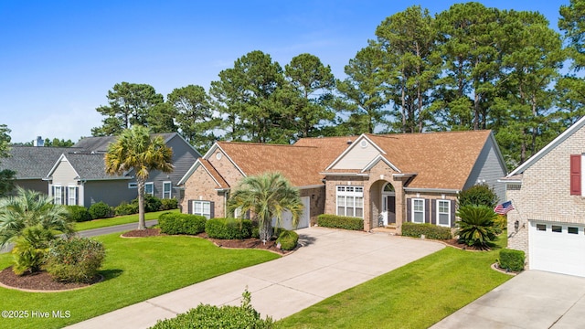 923 Meadowlands Trl, Calabash, NC 28467 - traditional home featuring concrete driveway, brick siding, and a front lawn