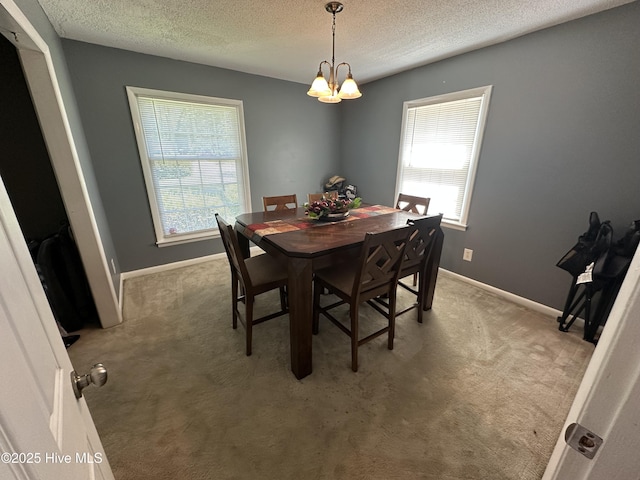 12760 S Pine Villa Dr, Laurinburg, NC 28352 - dining area with a textured ceiling, light colored carpet, and a chandelier