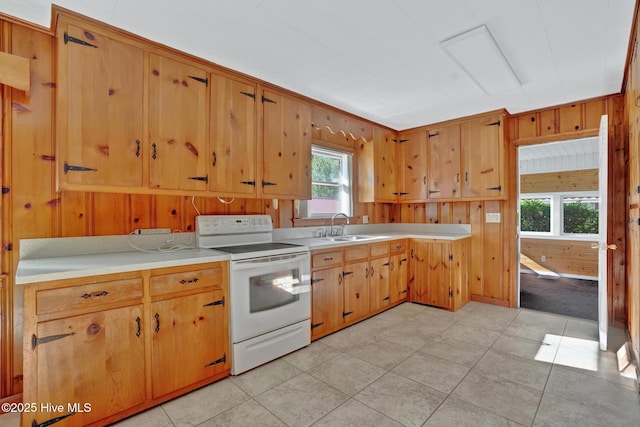 377 Louis Breeden Blvd, Hamlet, NC 28345 - kitchen featuring white electric range, light countertops, and wooden walls