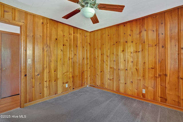377 Louis Breeden Blvd, Hamlet, NC 28345 - unfurnished room with carpet floors, wood walls, and a ceiling fan