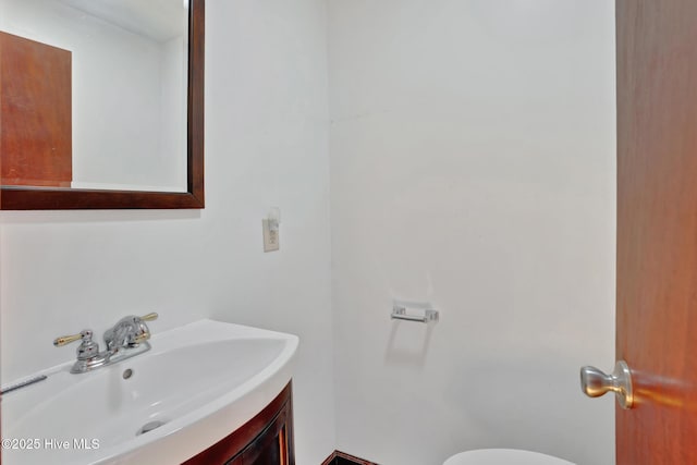 377 Louis Breeden Blvd, Hamlet, NC 28345 - half bath featuring vanity and toilet
