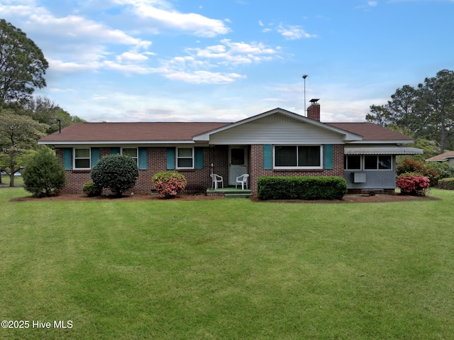 377 Louis Breeden Blvd, Hamlet, NC 28345 - ranch-style house featuring a chimney, a front lawn, and brick siding