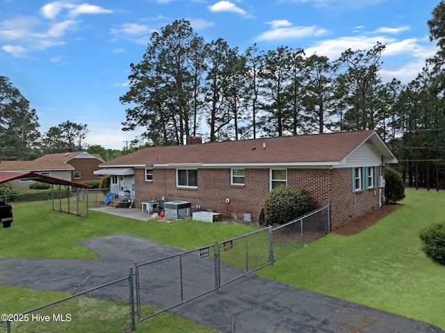 377 Louis Breeden Blvd, Hamlet, NC 28345 - rear view of property featuring a gate, brick siding, a patio area, and a chimney
