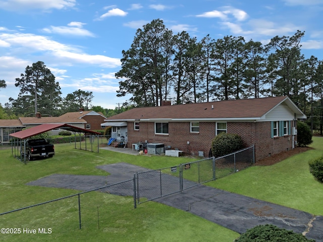 377 Louis Breeden Blvd, Hamlet, NC 28345 - back of property featuring a gate, brick siding, a carport, and asphalt driveway