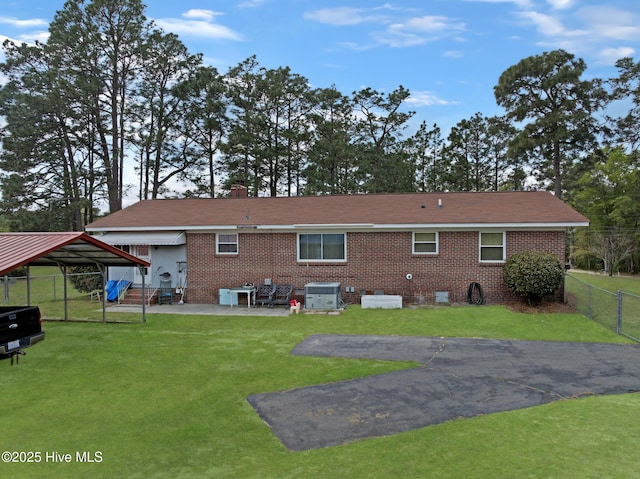 377 Louis Breeden Blvd, Hamlet, NC 28345 - back of property with a fenced backyard, brick siding, a chimney, and a patio