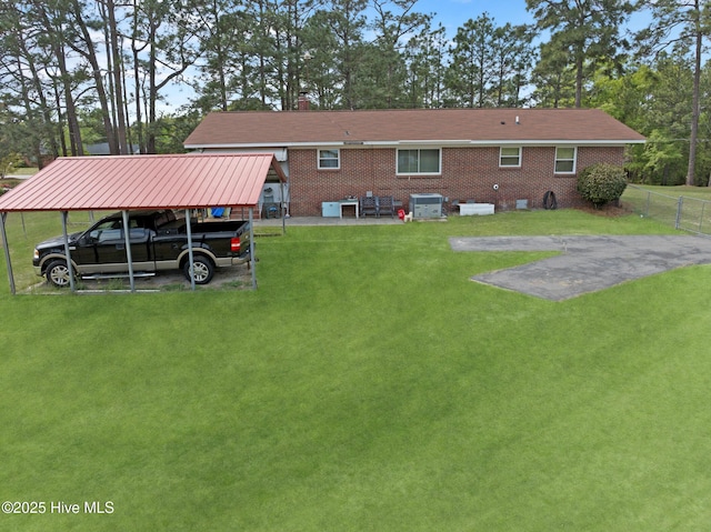 377 Louis Breeden Blvd, Hamlet, NC 28345 - back of house with a detached carport and brick siding