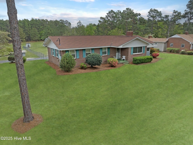 377 Louis Breeden Blvd, Hamlet, NC 28345 - ranch-style house with brick siding and a chimney