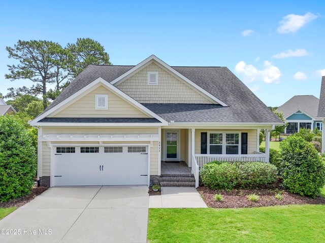 2955 Moorings Way SE, Southport, NC 28461 - craftsman house with driveway, covered porch, a garage, roof with shingles, and a front lawn
