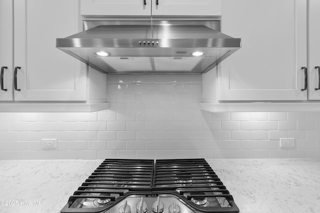 2955 Moorings Way SE, Southport, NC 28461 - kitchen with extractor fan, stainless steel gas stovetop, white cabinets, and tasteful backsplash