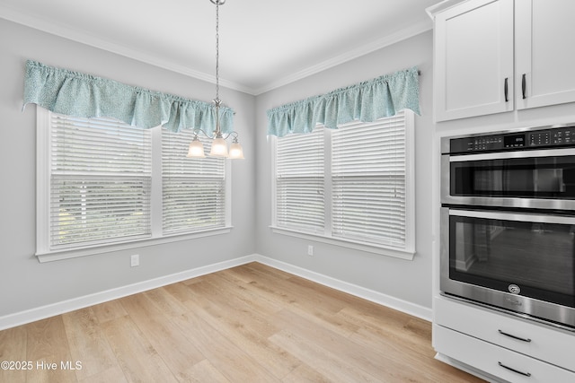 2955 Moorings Way SE, Southport, NC 28461 - unfurnished dining area with crown molding, light wood-style floors, plenty of natural light, and a chandelier