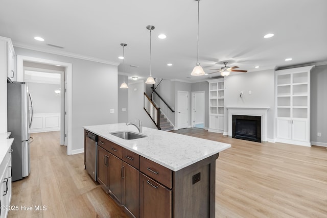 2955 Moorings Way SE, Southport, NC 28461 - kitchen featuring appliances with stainless steel finishes, ceiling fan, recessed lighting, ornamental molding, and light wood-type flooring