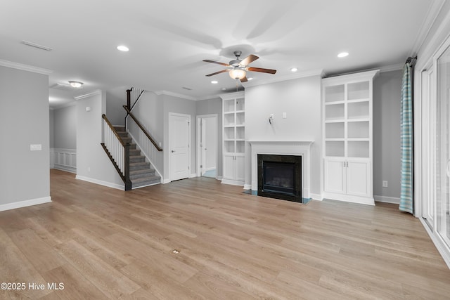 2955 Moorings Way SE, Southport, NC 28461 - unfurnished living room featuring a ceiling fan, recessed lighting, ornamental molding, a high end fireplace, and built in shelves