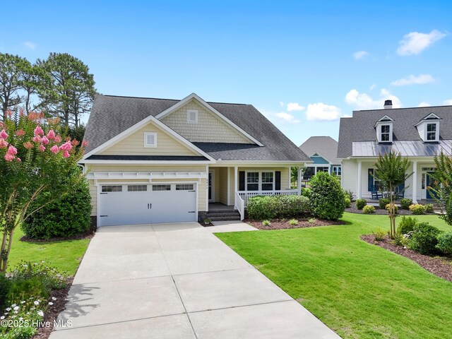 2955 Moorings Way SE, Southport, NC 28461 - craftsman-style house with a porch, a front lawn, a garage, concrete driveway, and a shingled roof