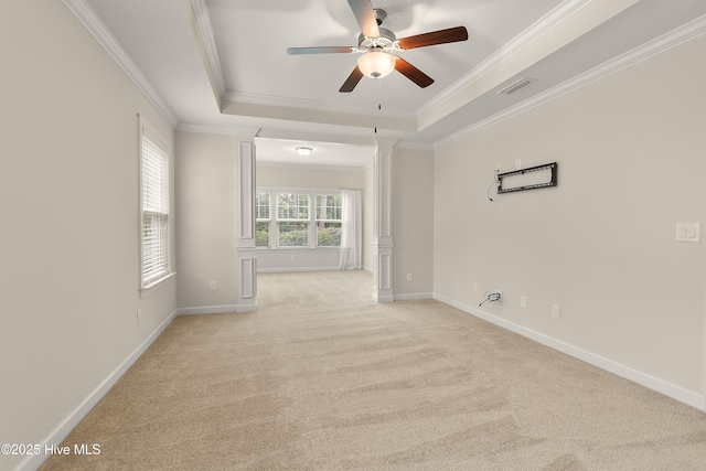 2955 Moorings Way SE, Southport, NC 28461 - spare room featuring ceiling fan, a tray ceiling, light carpet, ornamental molding, and decorative columns