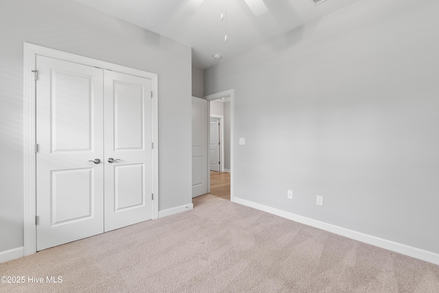 2955 Moorings Way SE, Southport, NC 28461 - unfurnished bedroom with carpet, a closet, and a ceiling fan