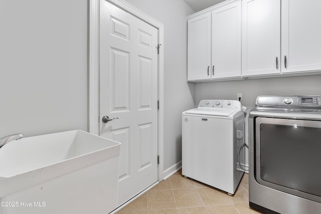 2955 Moorings Way SE, Southport, NC 28461 - laundry room featuring cabinet space, washing machine and clothes dryer, and light tile patterned floors