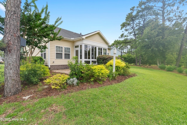 2955 Moorings Way SE, Southport, NC 28461 - view of property exterior featuring a lawn and a sunroom
