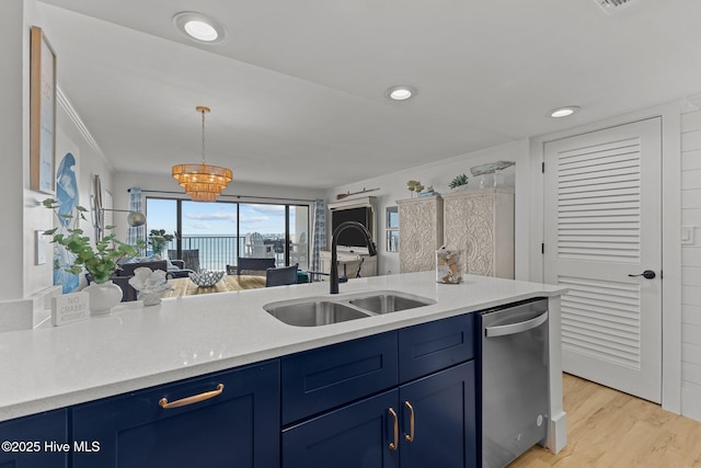 8801 Reed Dr Unit 303W, Emerald Isle, NC 28594 - kitchen featuring dishwasher, blue cabinets, ornamental molding, light countertops, and light wood-style floors