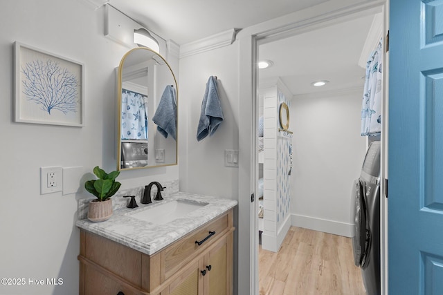 8801 Reed Dr Unit 303W, Emerald Isle, NC 28594 - bathroom with washer and clothes dryer, vanity, wood finished floors, crown molding, and recessed lighting