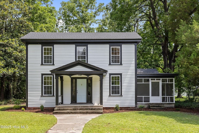 25967 US-264, Pantego, NC 27860 - view of front of house featuring a sunroom, a front lawn, and roof with shingles