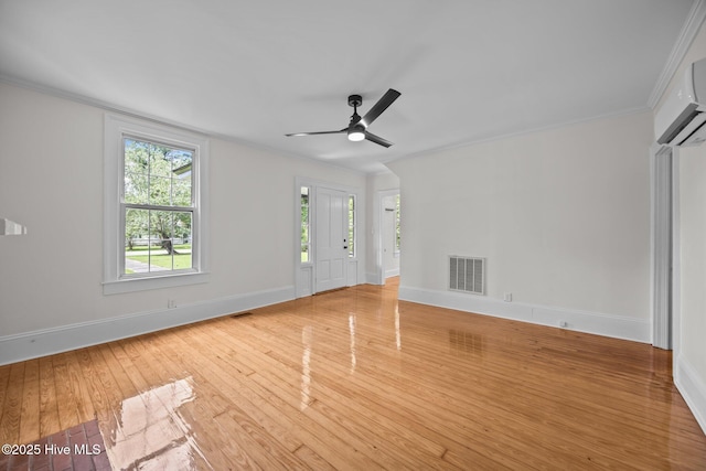 25967 US-264, Pantego, NC 27860 - unfurnished living room featuring crown molding, plenty of natural light, light wood-style floors, an AC wall unit, and ceiling fan