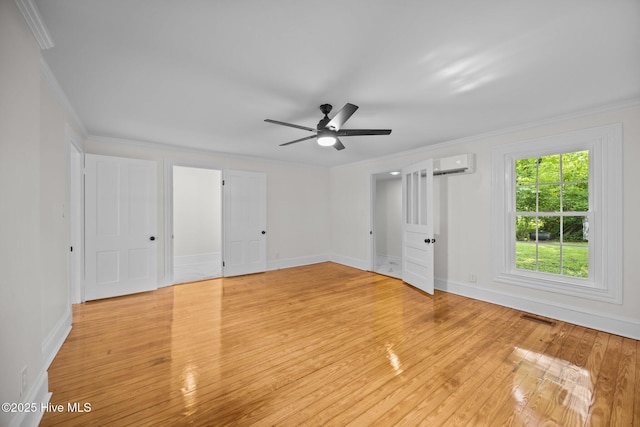 25967 US-264, Pantego, NC 27860 - unfurnished bedroom with a wall mounted AC, light wood-style flooring, crown molding, and ceiling fan