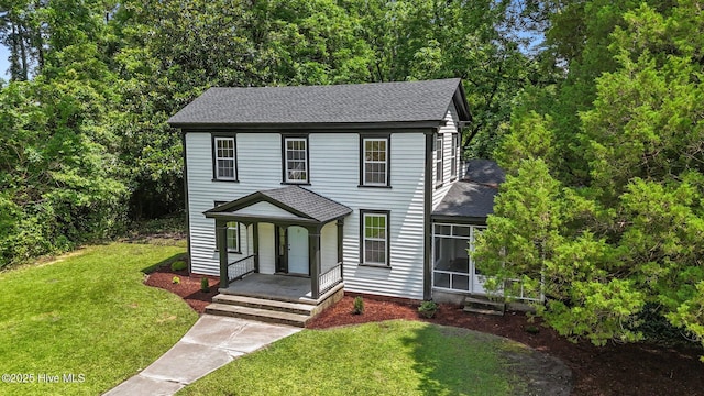 25967 US-264, Pantego, NC 27860 - colonial-style house featuring a shingled roof, covered porch, and a front yard
