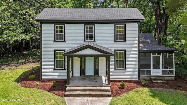 25967 US-264, Pantego, NC 27860 - view of front of home with roof with shingles, a sunroom, and a front lawn