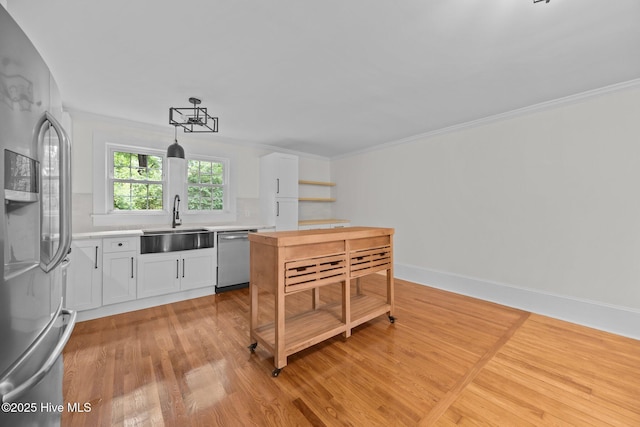 25967 US-264, Pantego, NC 27860 - kitchen featuring stainless steel appliances, light wood-style floors, white cabinetry, open shelves, and light countertops