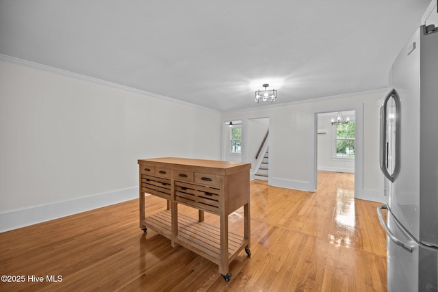 25967 US-264, Pantego, NC 27860 - entrance foyer with healthy amount of natural light, a chandelier, light wood-style flooring, crown molding, and stairs