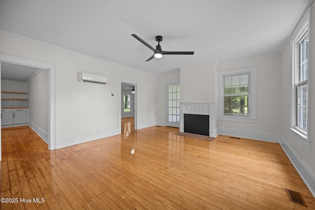 25967 US-264, Pantego, NC 27860 - unfurnished living room featuring an AC wall unit, ceiling fan, hardwood / wood-style floors, crown molding, and a fireplace with flush hearth