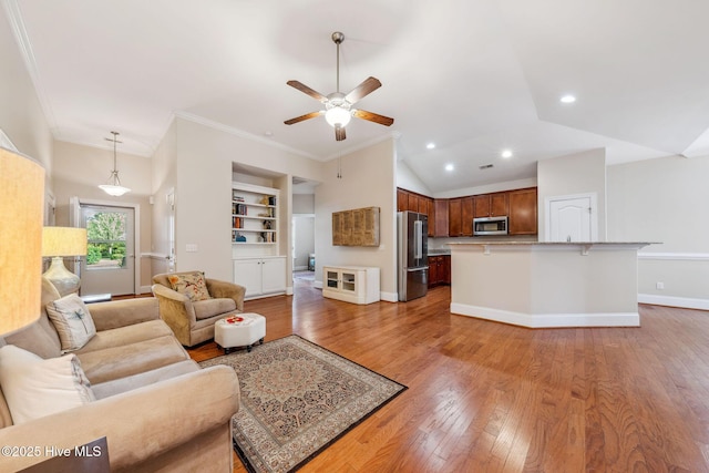 3716 Pond Pine Ct, Southport, NC 28461 - living area featuring light wood-style floors, ceiling fan, recessed lighting, built in shelves, and crown molding