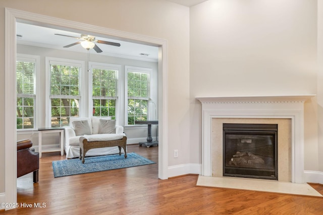 3716 Pond Pine Ct, Southport, NC 28461 - living room featuring ceiling fan, wood finished floors, ornamental molding, and a fireplace with flush hearth