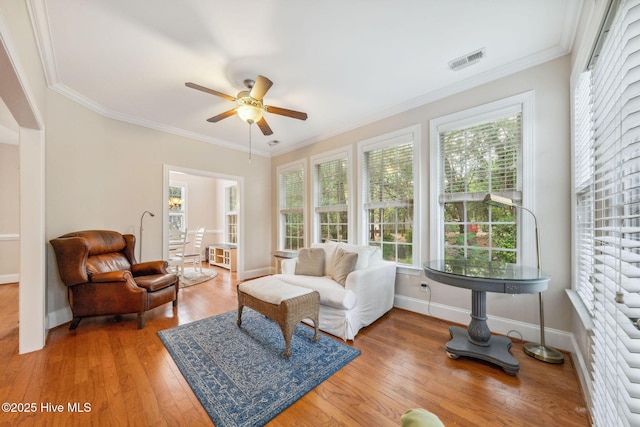 3716 Pond Pine Ct, Southport, NC 28461 - living room featuring ceiling fan, wood finished floors, and crown molding