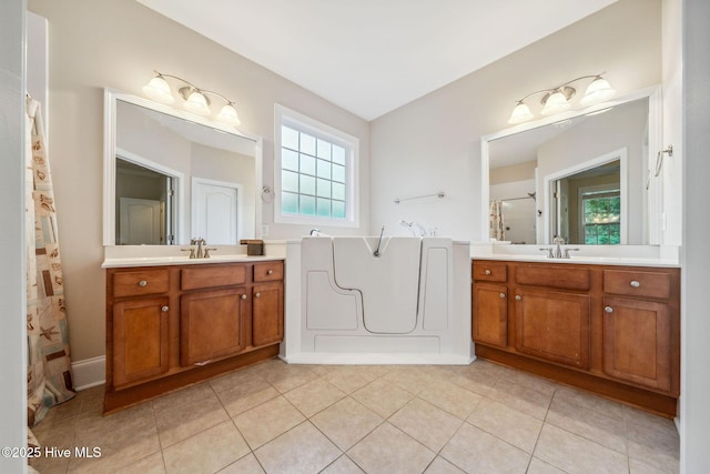 3716 Pond Pine Ct, Southport, NC 28461 - bathroom featuring a shower with shower door, two vanities, a bath, and tile patterned floors