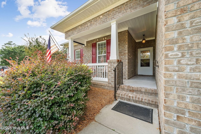 3716 Pond Pine Ct, Southport, NC 28461 - view of exterior entry featuring brick siding and covered porch