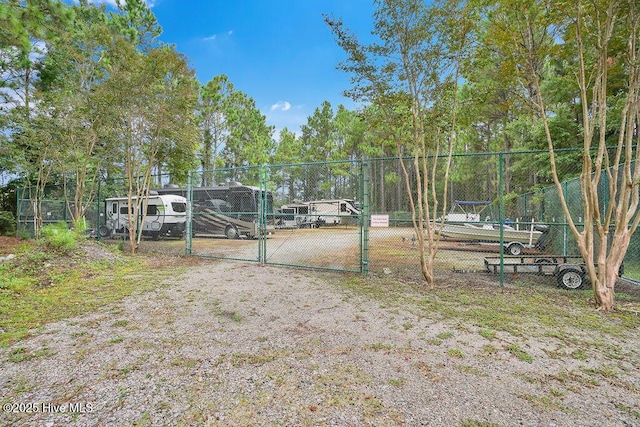 3716 Pond Pine Ct, Southport, NC 28461 - view of yard featuring a gate and view of scattered trees