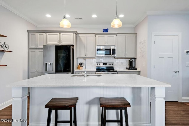 1022 Summer Woods Dr, Wilmington, NC 28412 - kitchen with stainless steel appliances, tasteful backsplash, a breakfast bar area, dark wood finished floors, and crown molding