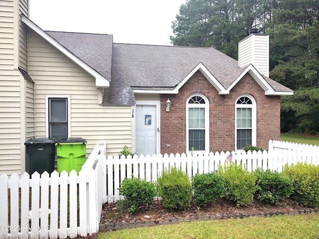 31 Mulberry Ln, New Bern, NC 28562 - view of front of property with a chimney, brick siding, and a shingled roof