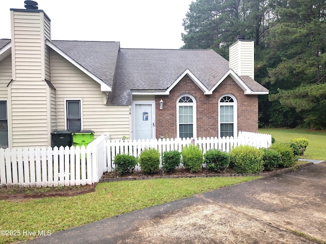 31 Mulberry Ln, New Bern, NC 28562 - view of front of house with a chimney, a shingled roof, and brick siding