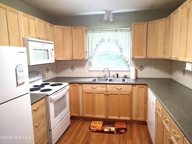31 Mulberry Ln, New Bern, NC 28562 - kitchen with white appliances, light wood-type flooring, light brown cabinets, decorative backsplash, and dark countertops