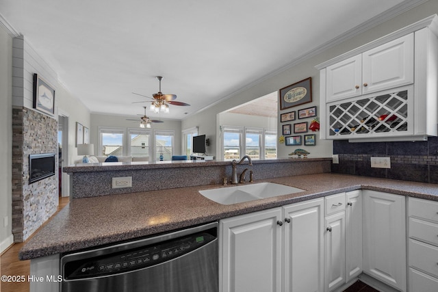 120 Windjammer Dr, Surf City, NC 28445 - kitchen featuring dishwasher, dark countertops, white cabinets, plenty of natural light, and crown molding