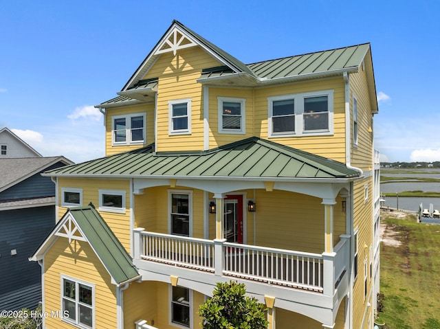 120 Windjammer Dr, Surf City, NC 28445 - view of front facade featuring a standing seam roof, a balcony, and a metal roof