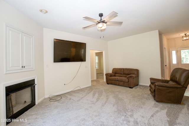 130 Pinecone Ct, Seven Lakes, NC 27376 - living room with carpet floors, a fireplace, ceiling fan, and a chandelier