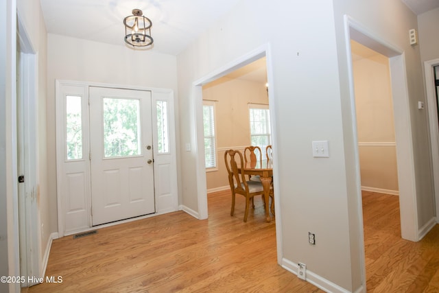 130 Pinecone Ct, Seven Lakes, NC 27376 - foyer featuring light wood-type flooring and a chandelier