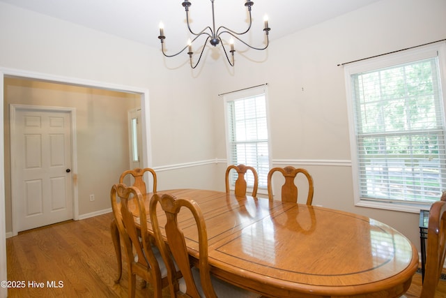 130 Pinecone Ct, Seven Lakes, NC 27376 - dining space featuring a chandelier, healthy amount of natural light, and wood finished floors