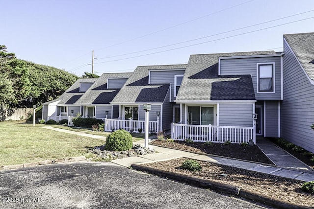 130 Salter Path Rd Unit 74, Pine Knoll Shores, NC 28512 - view of front of property featuring covered porch, a shingled roof, and a front lawn