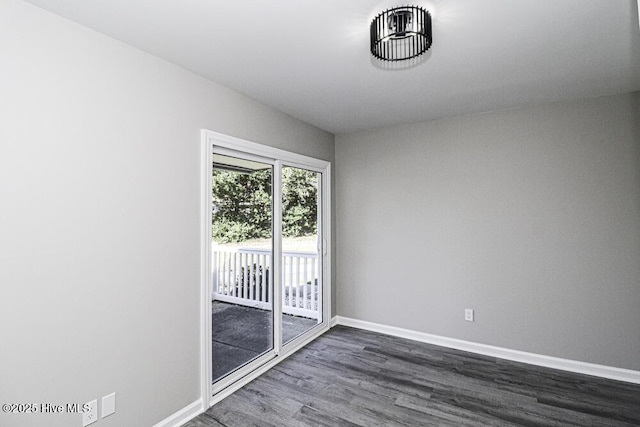 130 Salter Path Rd Unit 74, Pine Knoll Shores, NC 28512 - unfurnished room with dark wood-type flooring and baseboards