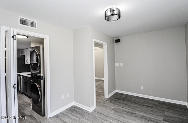 130 Salter Path Rd Unit 74, Pine Knoll Shores, NC 28512 - laundry area with stacked washer / drying machine and wood finished floors